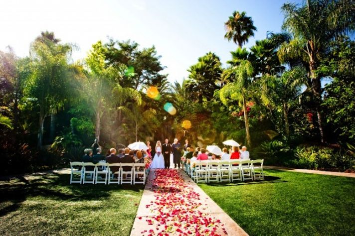 Small destination wedding ceremony aisle with rose petals