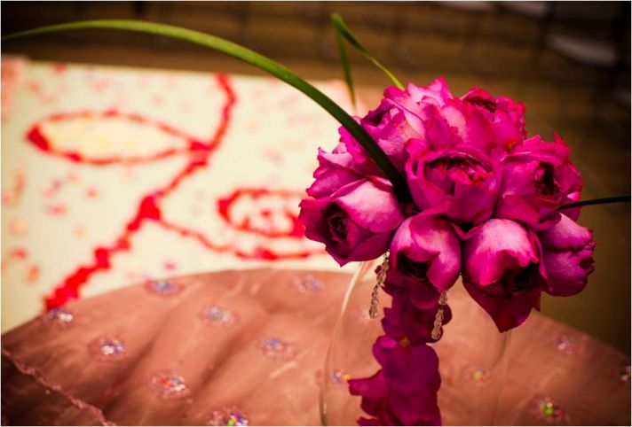 Gorgeous deep pink DIY bridal bouquet and rose petal ceremony aisle