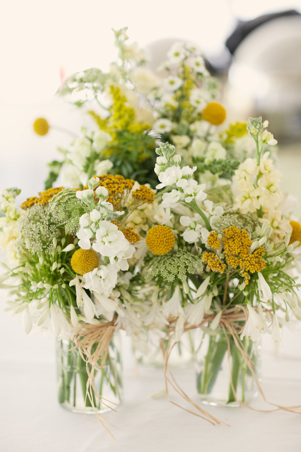 Outdoor-spring-wedding-yellow-white-wedding-flower-centerpieces.full