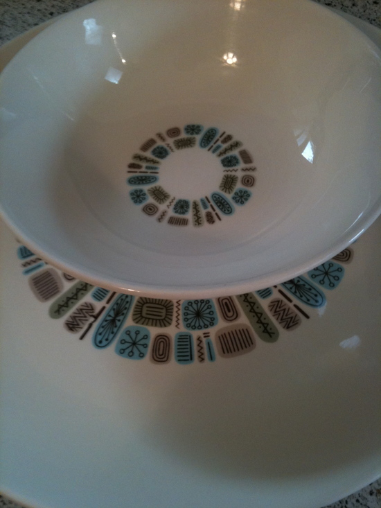 These dishes are off-white with a retro blue and green circular pattern in the middle