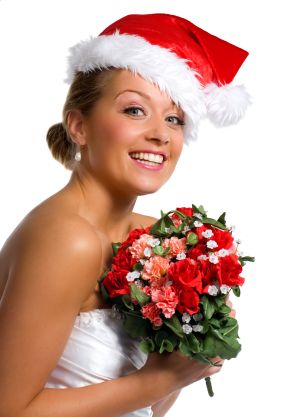 This bride�s pink and red rose bouquet and santa hat have her ready to be a Christmas bride.