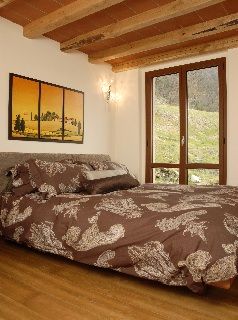 This modernist bedroom has a rustic and romantic feel.