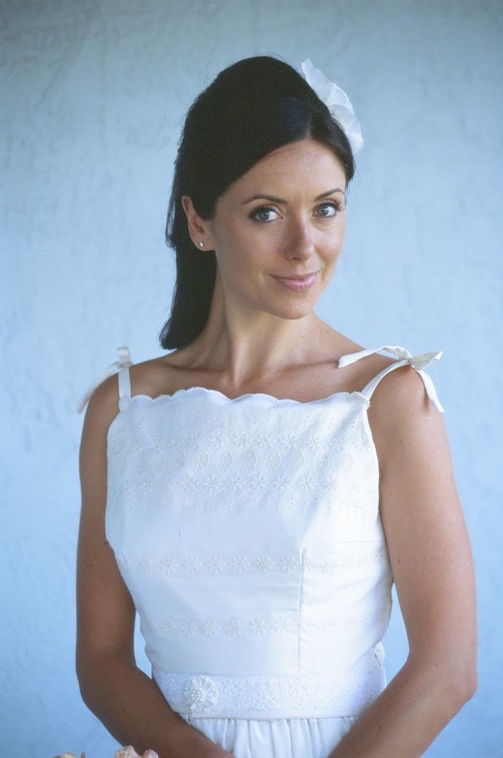 White lace wedding dress with tie straps and high neckline