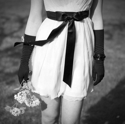Chic blush pink mini dress for your wedding reception tied with black sash