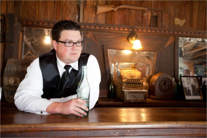 Austin, Texas best man has a drink in old western saloon before the wedding