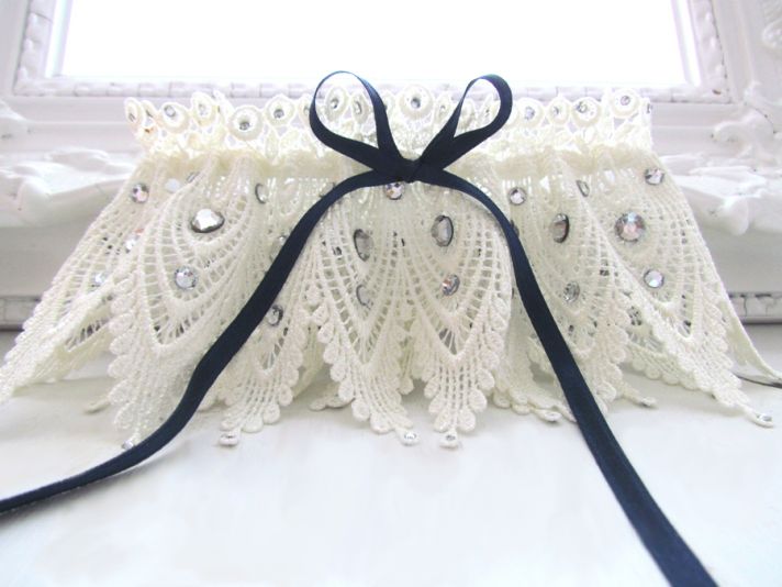Vintage-chic ivory lace bridal garter with something blue navy satin ribbon and rhinestone details