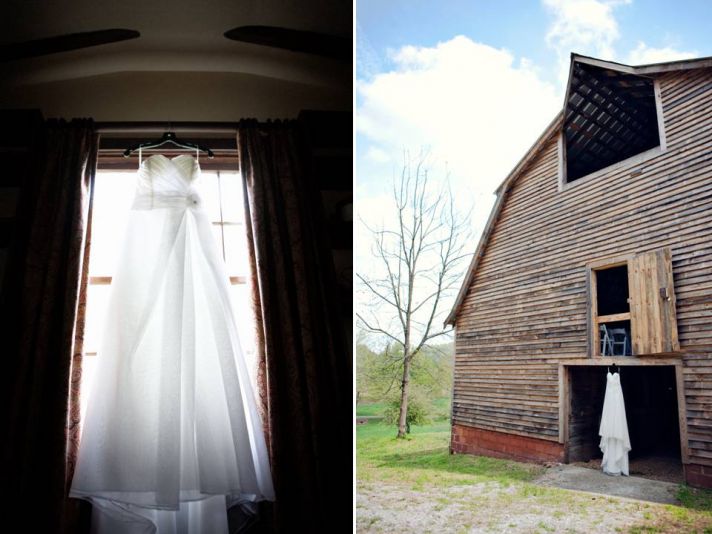 Simple white sweetheart wedding dress hangs in window of rustic wedding venue