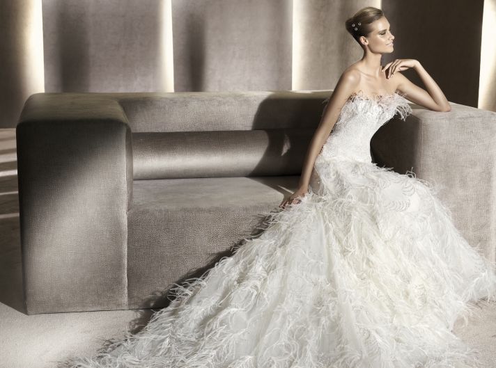 Ivory wedding dress covered with romantic feathers