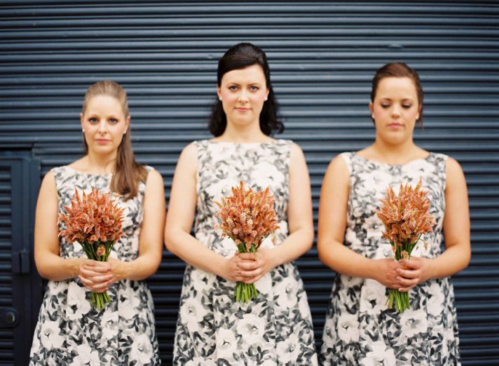 black white printed bridesmaids dresses orange bouquets