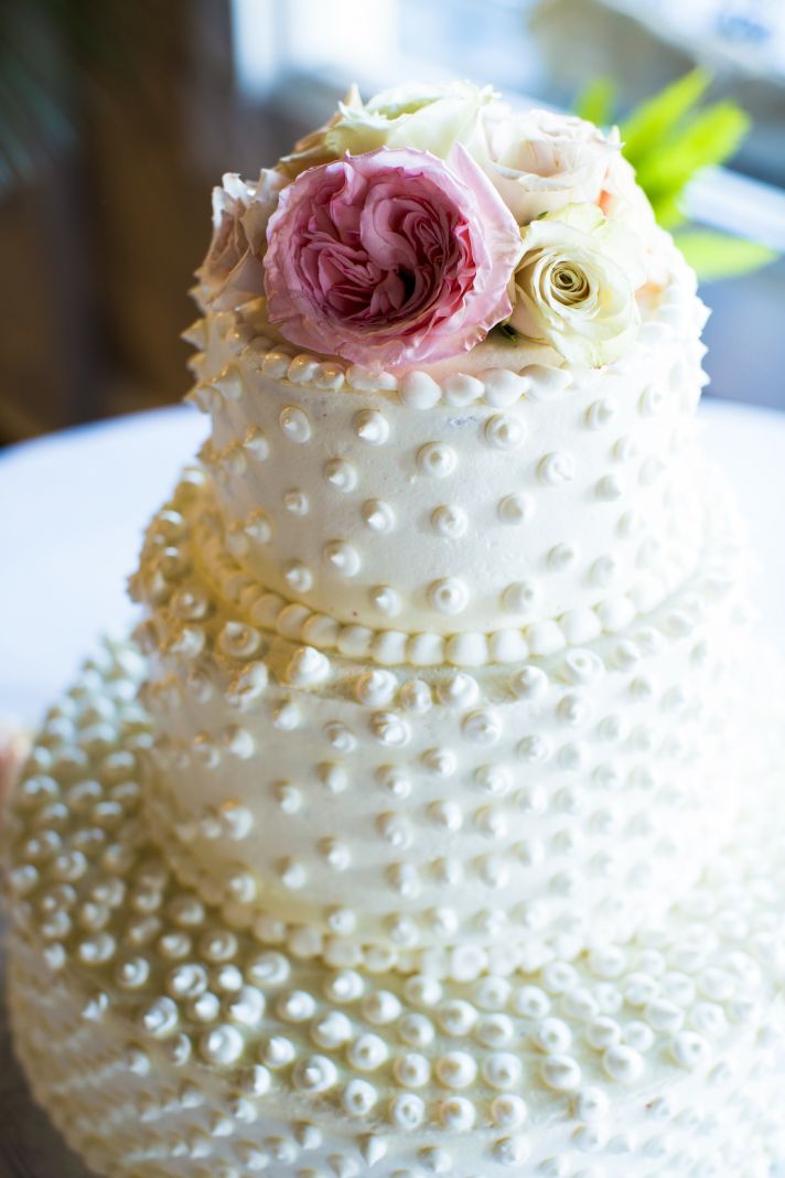 Classic ivory wedding cake with pearl polka dots