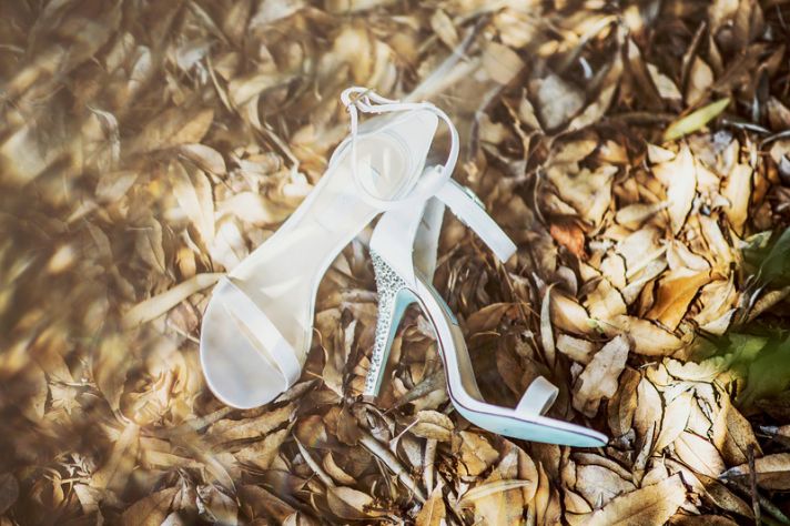 White wedding shoes with metallic studded heels