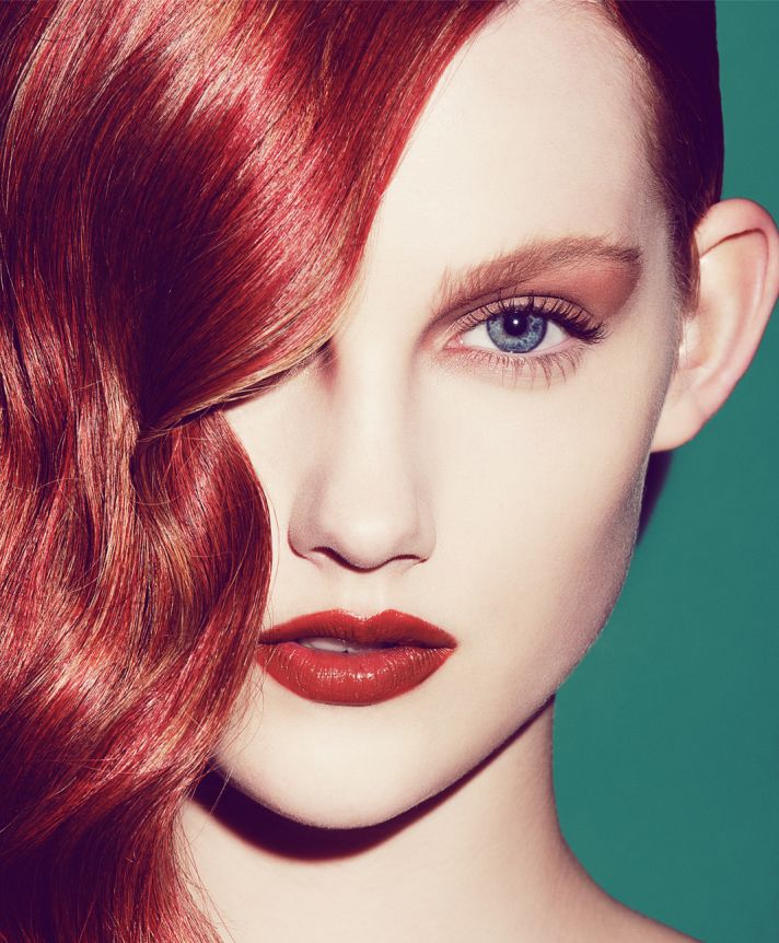 Wedding makeup look with bronze lids red lips and hair