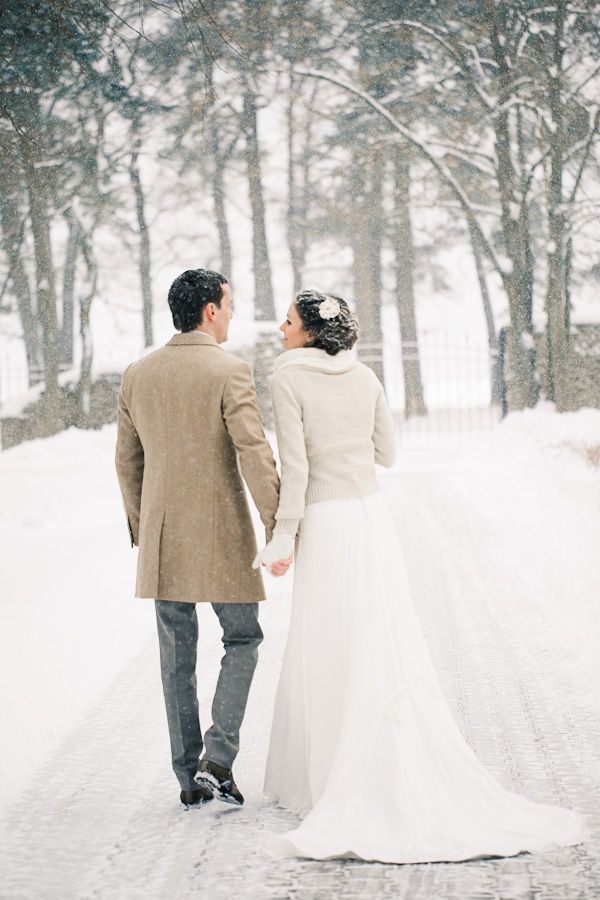 winter bride wears a fur trimmed wedding sweater