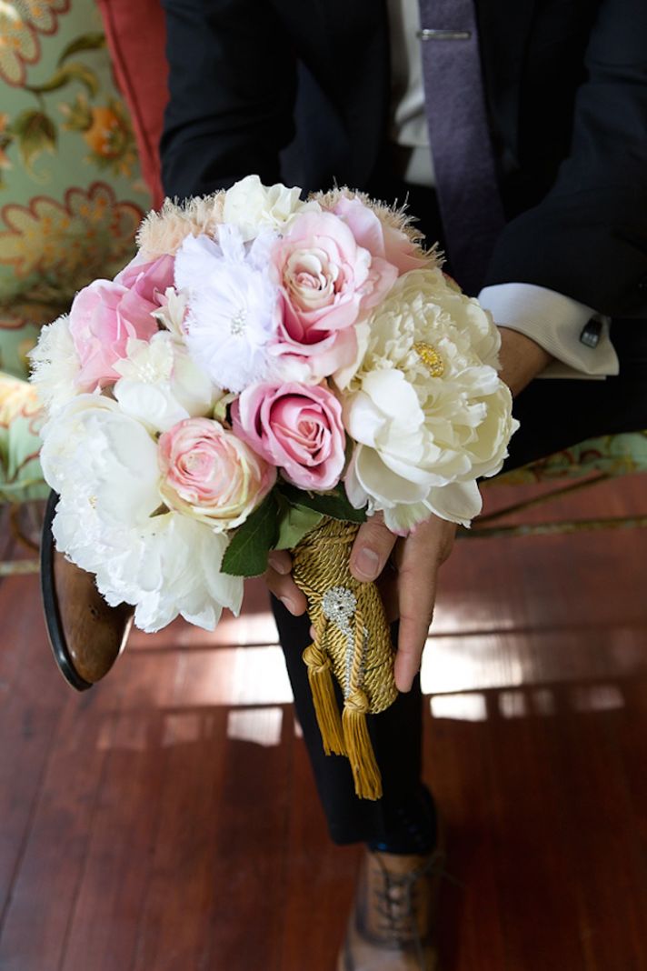Peonies and roses bouquet with feathers