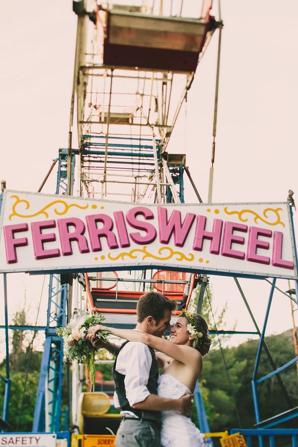 Kiss In Front of Ferris Wheel Wedding Photo