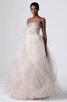 Strapless wedding dress swathed in white tulle over pink rose appliques