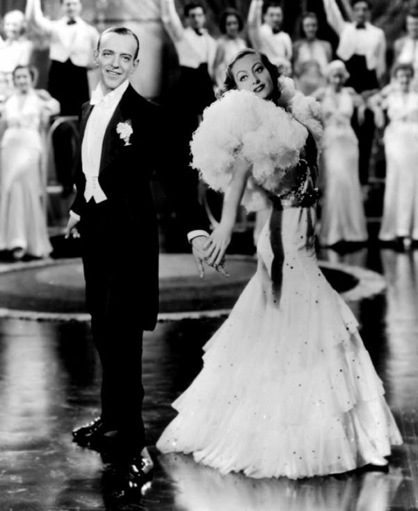 Joan Crawford in old black and white film, wears gorgeous white mermaid silhouette gown
