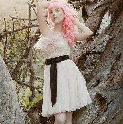Edgy pink-haired bride wears soft pink flirty frock with black sash