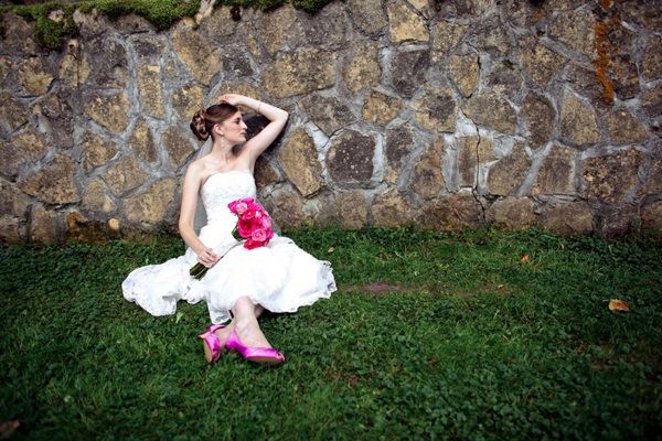This bride�s bright pink bouquet matches her bright pink shoes.