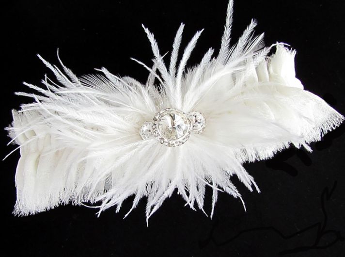 White wedding garter adorned with feathers and crystals