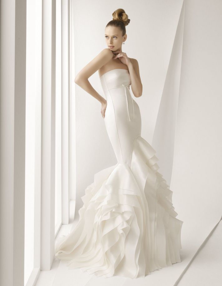 Stunning ivory strapless mermaid wedding dress with textured skirt and dainty bow