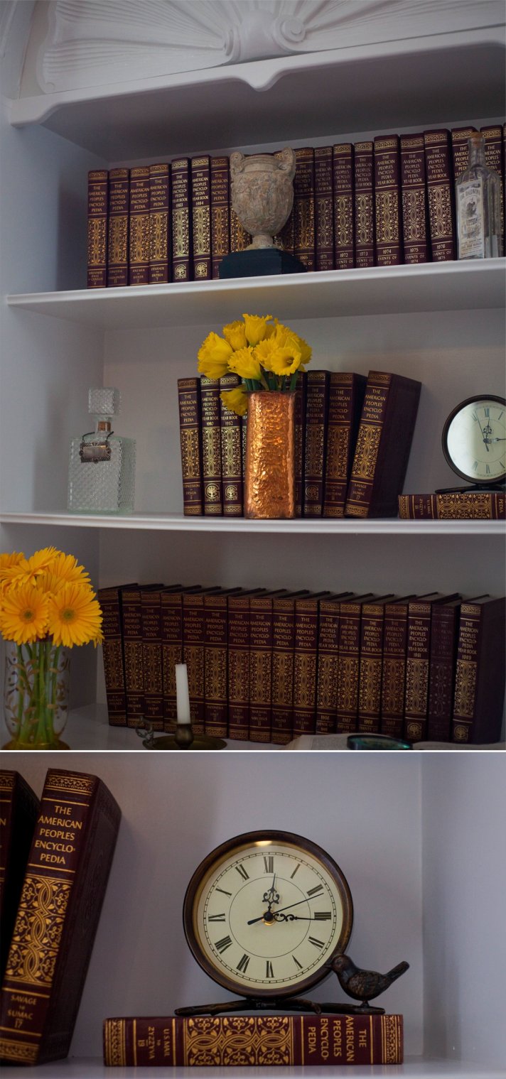 Vintage bookshelf adorned with yellow wedding flowers
