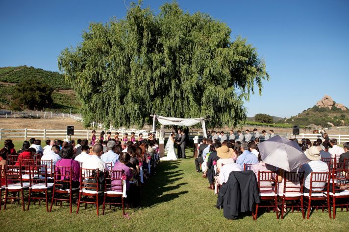 elegant California wedding with bold florals personalized details getting married under a tree