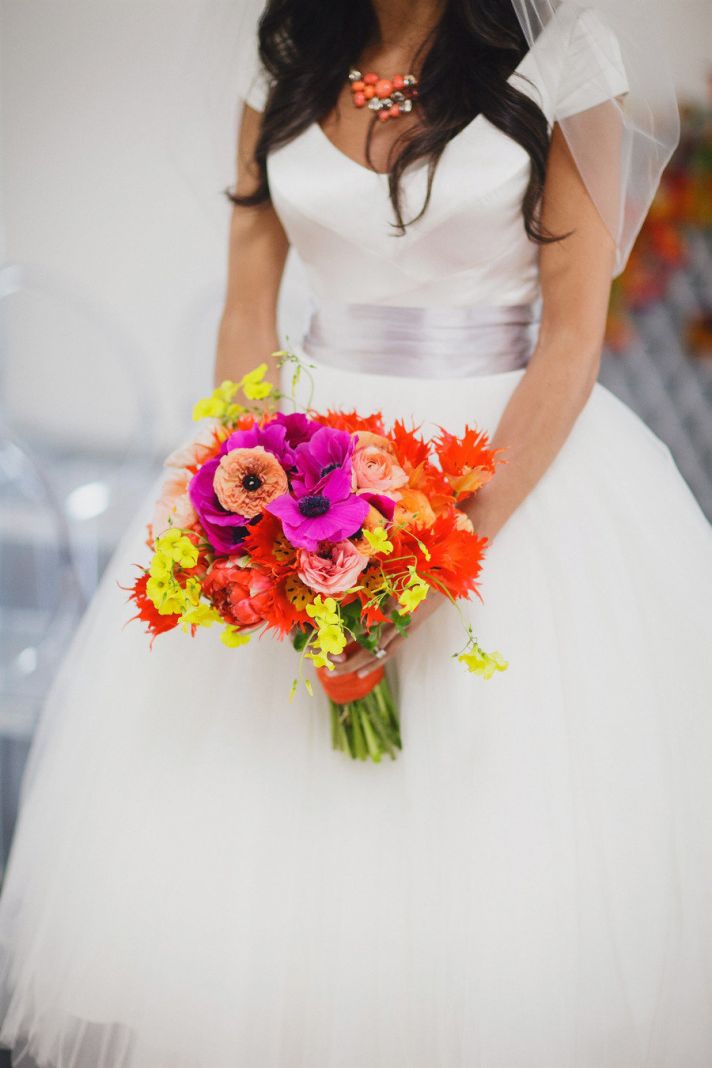rainbow neon wedding backdrop with bright bold flowers