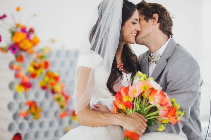 rainbow neon wedding backdrop with bright bold flowers