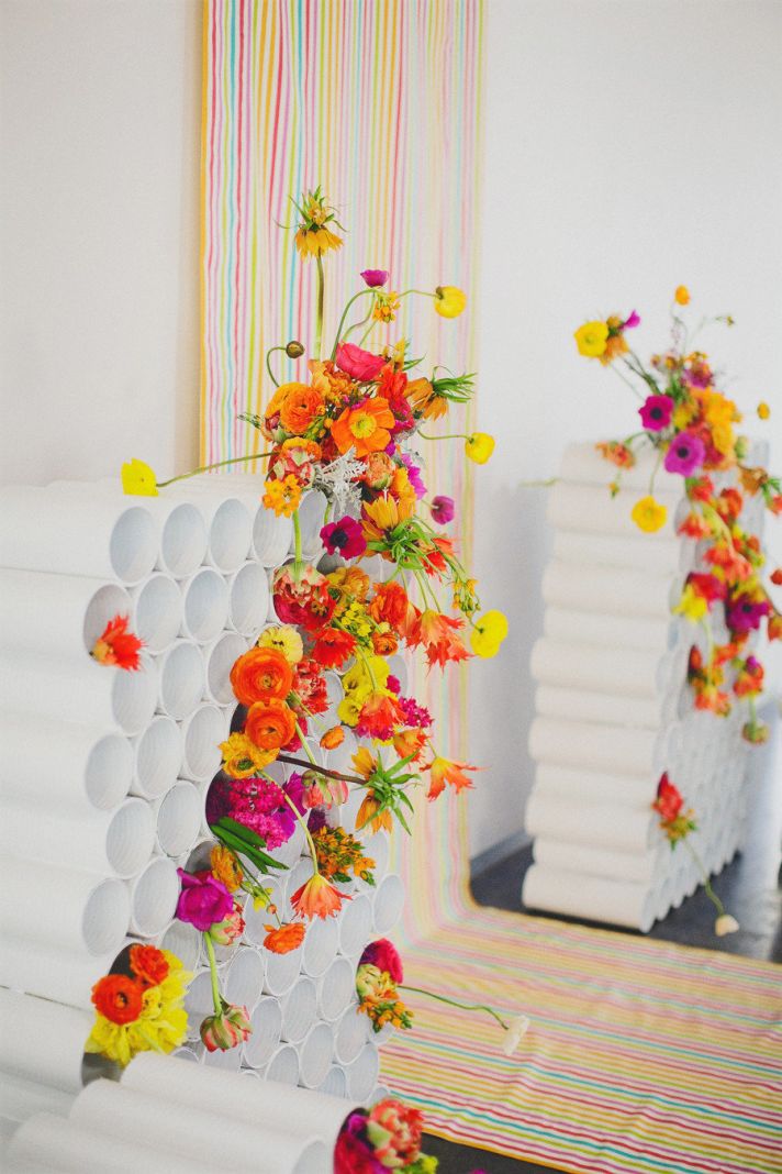 rainbow neon wedding backdrop with bright bold flowers