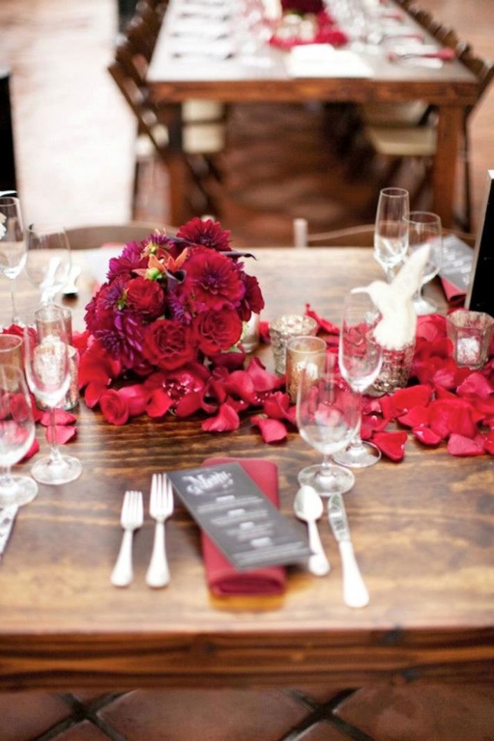 outdoor wedding reception with deep red flowers