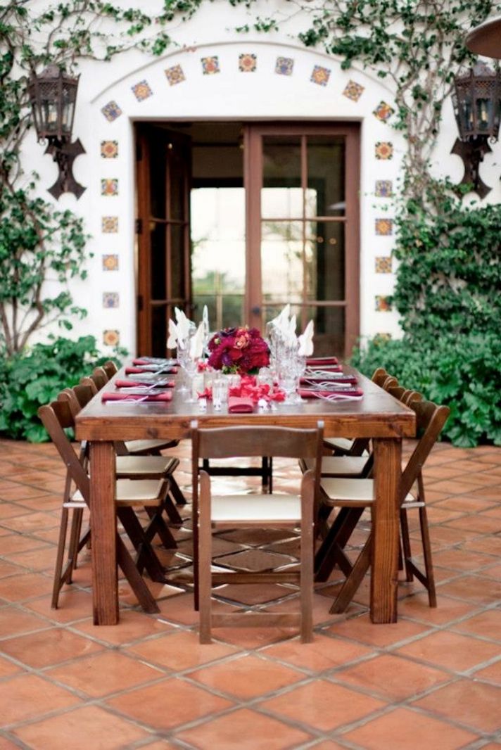 outdoor wedding reception with deep red flowers