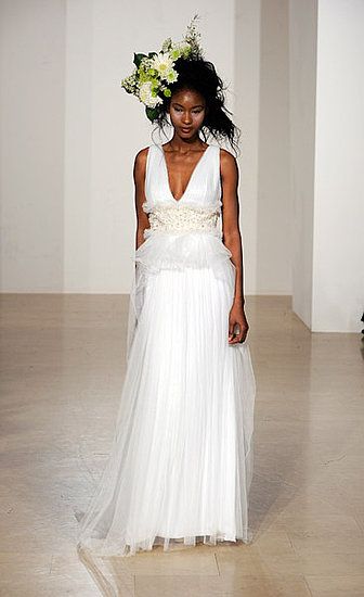 Empire style wedding dress with deep v-neck and flirty ruffle details