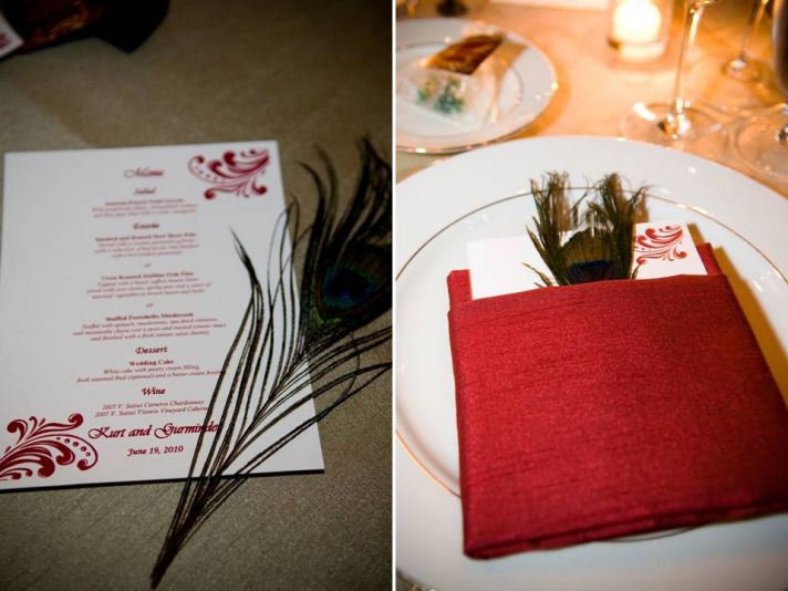 Red, white and gold wedding reception decor and stationery with peacock feather details