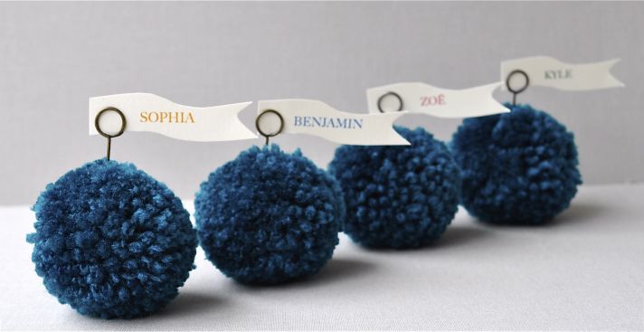 Adorable wedding reception escort card holders- turquoise blue pom poms