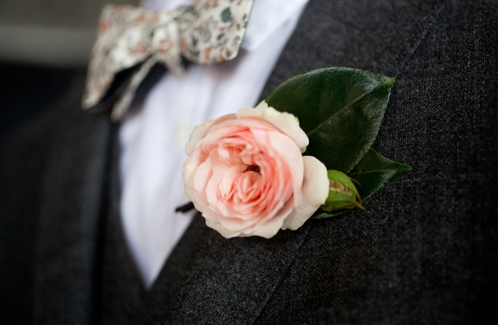 groom wears patterned bow tie charcoal grey suit