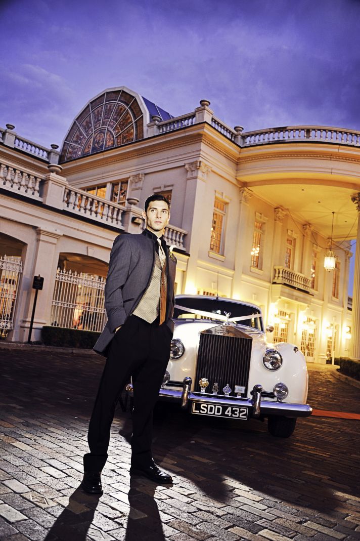 Opulent Wedding Venue Vintage Groom Poses with Rolls Royce