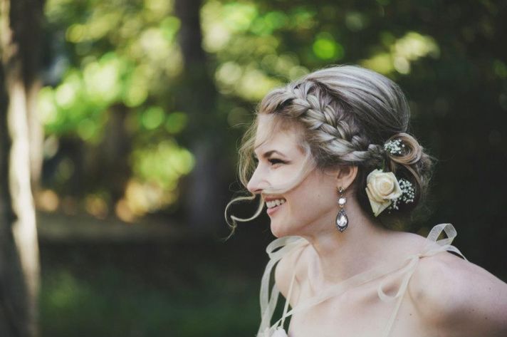 romantic braided wedding hairstyle with curly tendrils