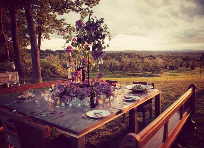 Outdoor square reception table with purple centerpiece