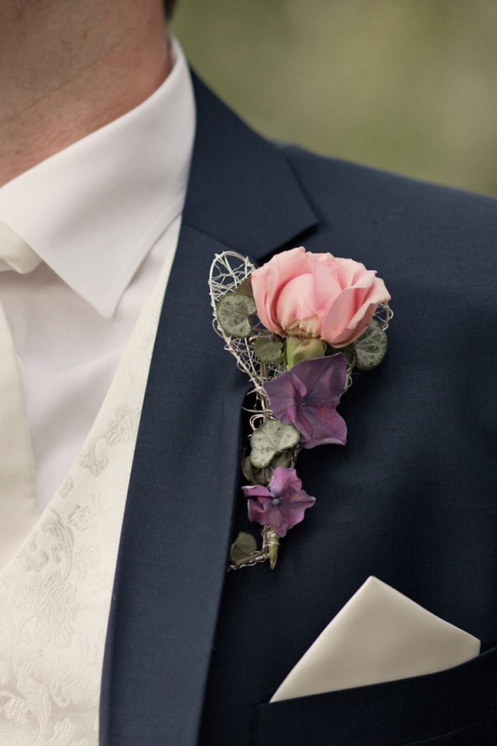Groom boutonniere with a pink rose