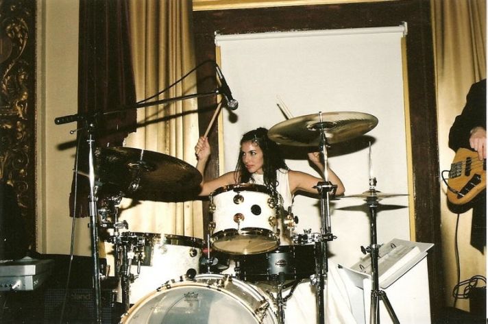 The beautiful bride plays the drums, making her wedding reception truly memorable.