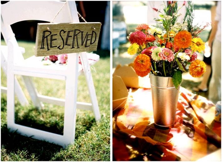 Handmade “Reserved” sign made of wood; vibrant orange, yellow and pink floral centerpiece