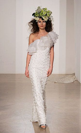 Asymmetrical neckline wedding dress with ruffled shoulder and sheath silhouette