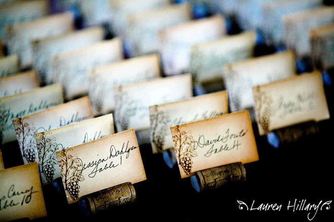 Antique looking escort cards sit in individual wine corks