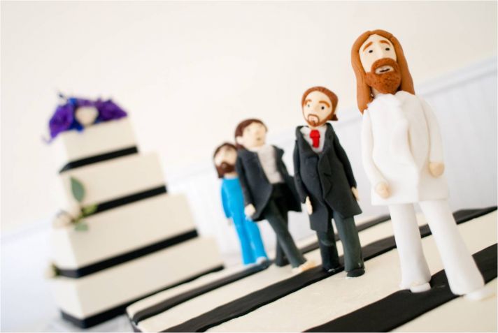 Fun wedding cake toppers adorn classic wedding cake