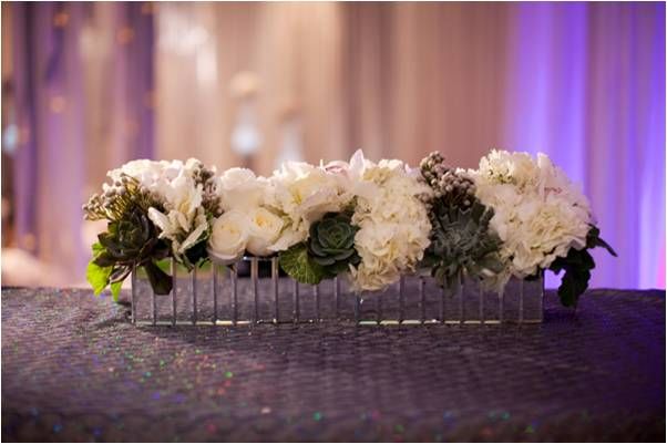 Romantic and classic wedding ceremony floral arrangement with white roses and luscious succulents