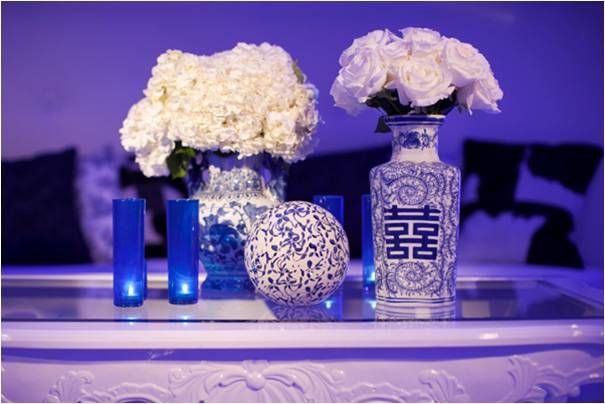 Antique vases for ‘something old’, white wedding flowers and blue lighting