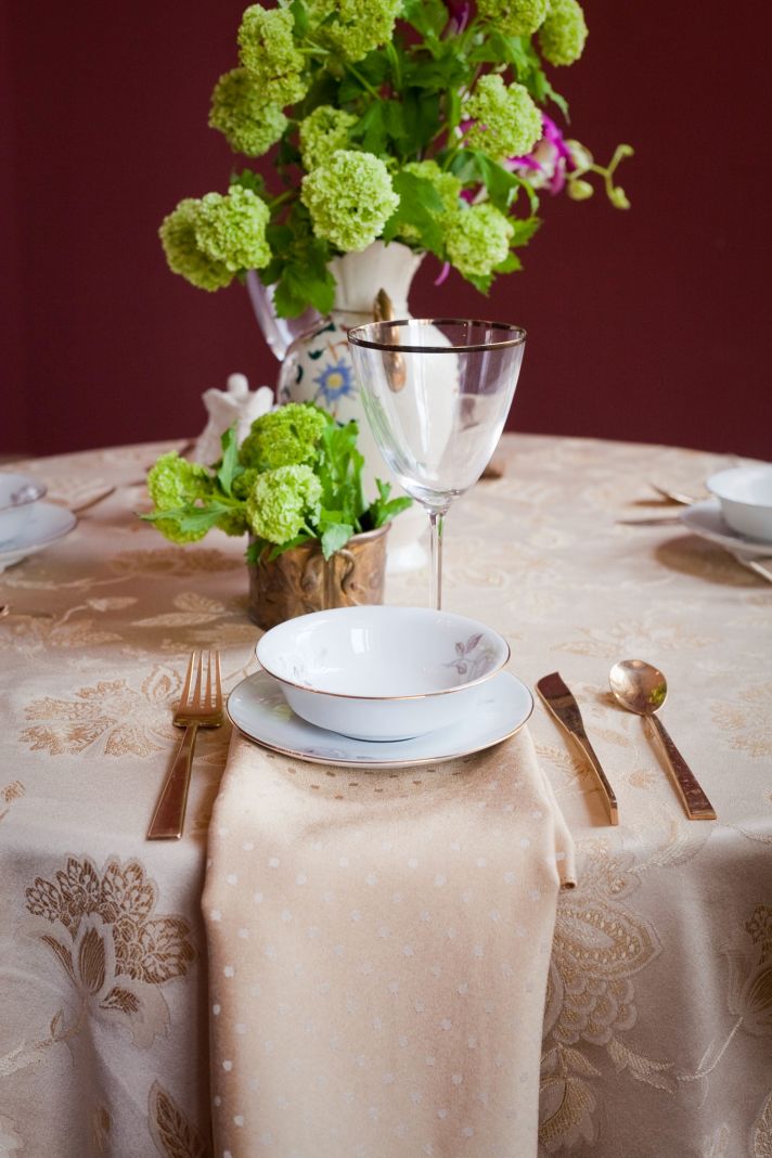 Regal gold wedding reception tablescape with bright wedding flowers