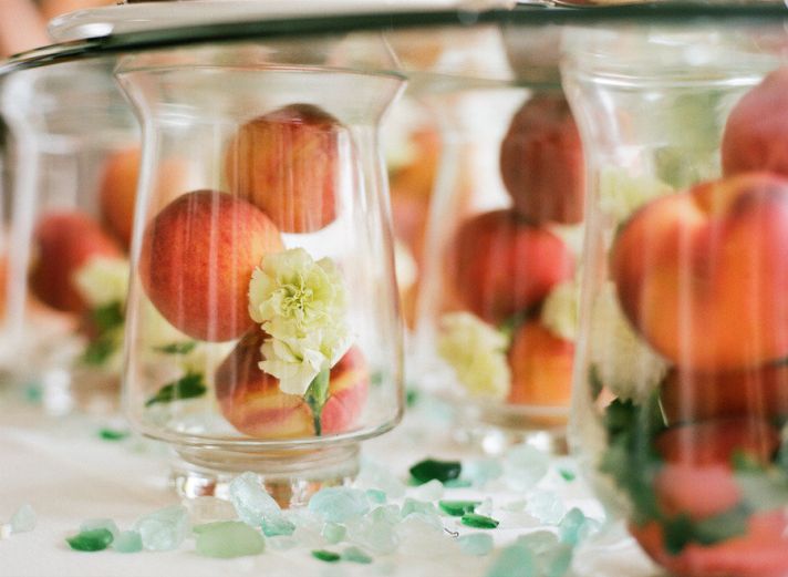 fruit incorporated into wedding reception centerpieces peaches hold escort cards