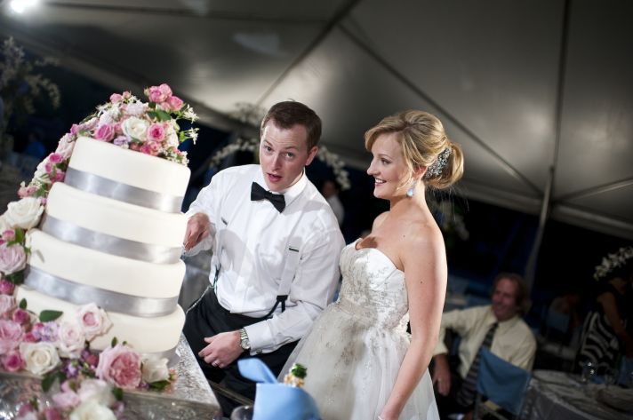 classic real wedding in fall bride groom cut wedding cake